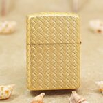 Woven braid gold-tone Zippo Armor lighter texture close-up
