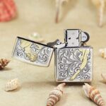 Open silver-tone Arabesque Zippo Armor lighter with gold ribbon detail