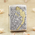 Lighter with ornate black-and-white scrollwork and a stylized nude woman illustration in gold tones.