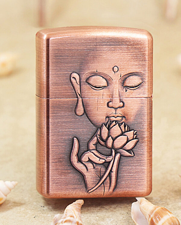 KZ288-01 Copper-colored lighter with an engraved meditative face and lotus blossom motif on the front surface.