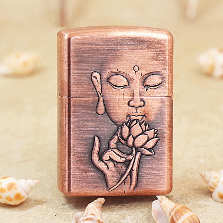 Copper-colored lighter with an engraved meditative face and lotus blossom motif on the front surface.