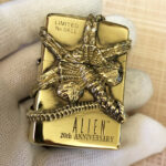 H.R. Giger Alien Emblem No. 1 high-polish brass Zippo lighter front view