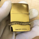 H.R. Giger Alien Emblem No. 1 brass Zippo lighter alternate angle