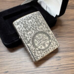 Son of Satan Pentagram sterling silver Zippo Armor lighter – front view of the pentagram and floral engraving beside the original box