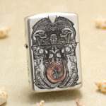 H.R. Giger Alien five-side sterling silver Zippo Armor lighter – front view showing biomechanical Alien relief with darkened and copper-toned details