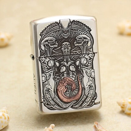H.R. Giger Alien five-side sterling silver Zippo Armor lighter – front view showing biomechanical Alien relief with darkened and copper-toned details