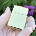 Napoleon brass Zippo Armor lighter beside original box