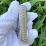 Close side view of the fine vertical ribbing on the Holy Bible sterling silver Zippo Armor lighter