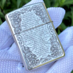 Reverse view with scripture-inspired text and ornamental border on the sterling silver Zippo Armor lighter