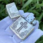 Open front view showing the cross design, engraved lid, and Zippo insert