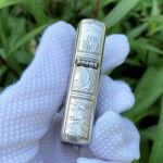 Hinge-side view of the Holy Bible title and scroll engraving