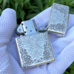 Open reverse view showing scripture-inspired text and engraved lid on the sterling silver Armor lighter