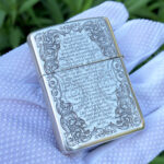 Angled reverse view of the scripture and ornamental engraving on the Holy Bible sterling silver lighter