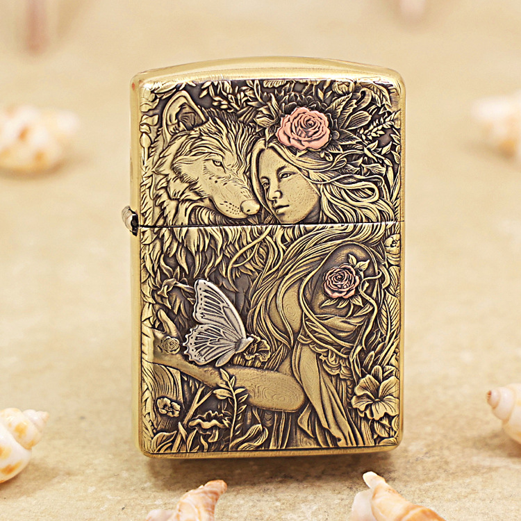 Brass lighter with an intricate engraved scene of a woman, a wolf, flowers, and a butterfly.