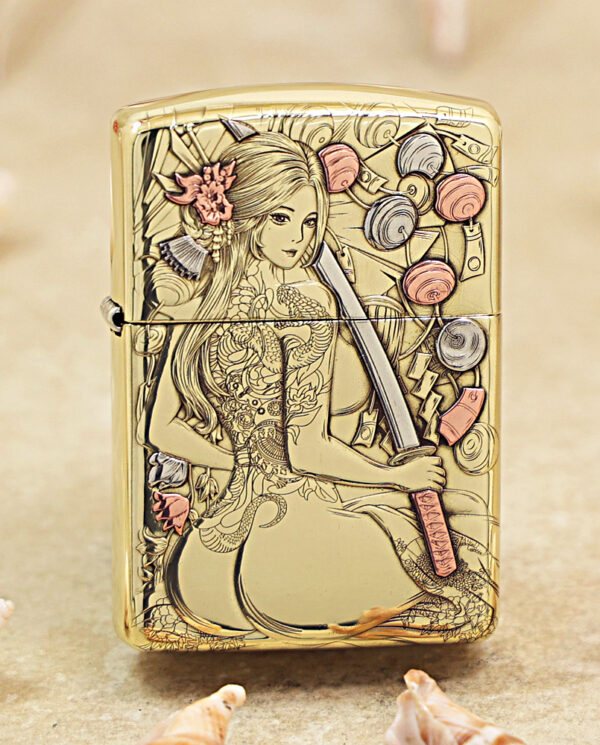 KZ457 Gold Zippo lighter engraved with a stylized woman with long hair, holding a sword, surrounded by floral motifs and decorative swirls.