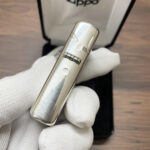 Hinge-side profile with tree engraving on the sterling silver Armor lighter