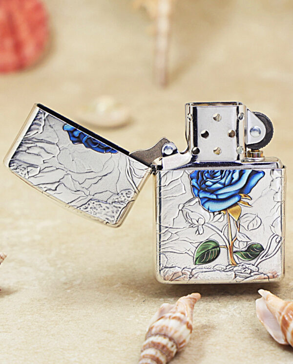 KZ461-02 Opened Zippo-style lighter with a cracked-silver surface and a blue rose motif on the body and lid.”