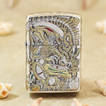 H.R. Giger Alien silver-tone Zippo Armor lighter with gold accents