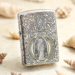 Front view of Zippo Armor silver-tone St. Benedict figure engraved lighter