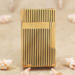 Karl Wieden KW-T02J petrol lighter, front view showing gold-plated vertical lines and a polished Karl Wieden branded band