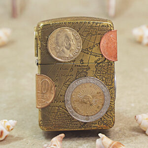 Travel-themed vintage lighter with a map engraving and several coins attached to its surface on a beige background.