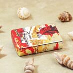 Decorative metal tin with red and gold Chinese motifs on a beige surface, surrounded by seashells.