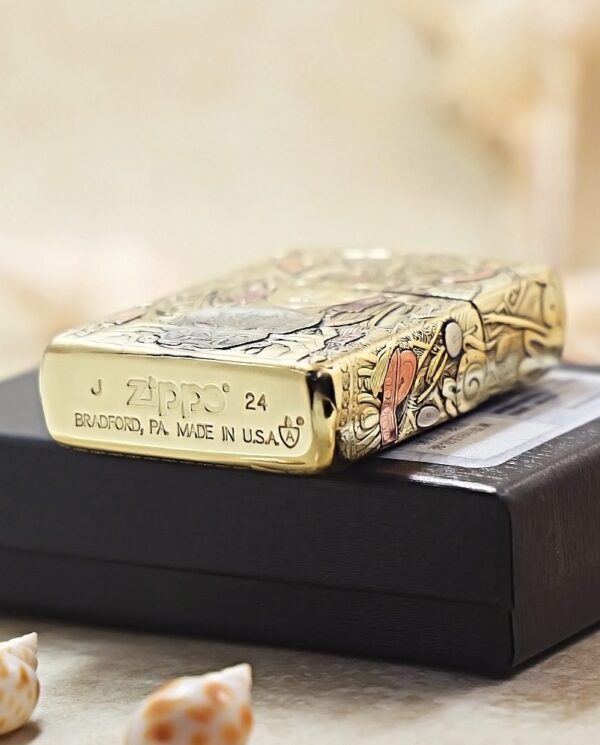 KZ501-05 Decorative Zippo lighter with floral engravings resting on a black box; base reads Zippo, Bradford, PA, Made in USA and '24'.