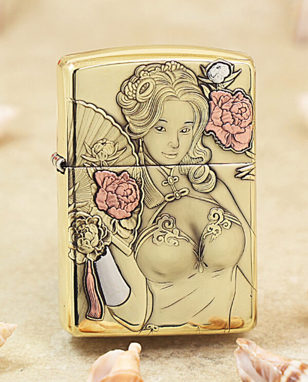 KZ506 Gold Zippo lighter with an ornate line drawing of a woman surrounded by pink flowers and a fan motif,