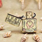 Gold Zippo lighter open to reveal a cartoon-style scene of a woman at a poker table with cards and chips, seashells around.