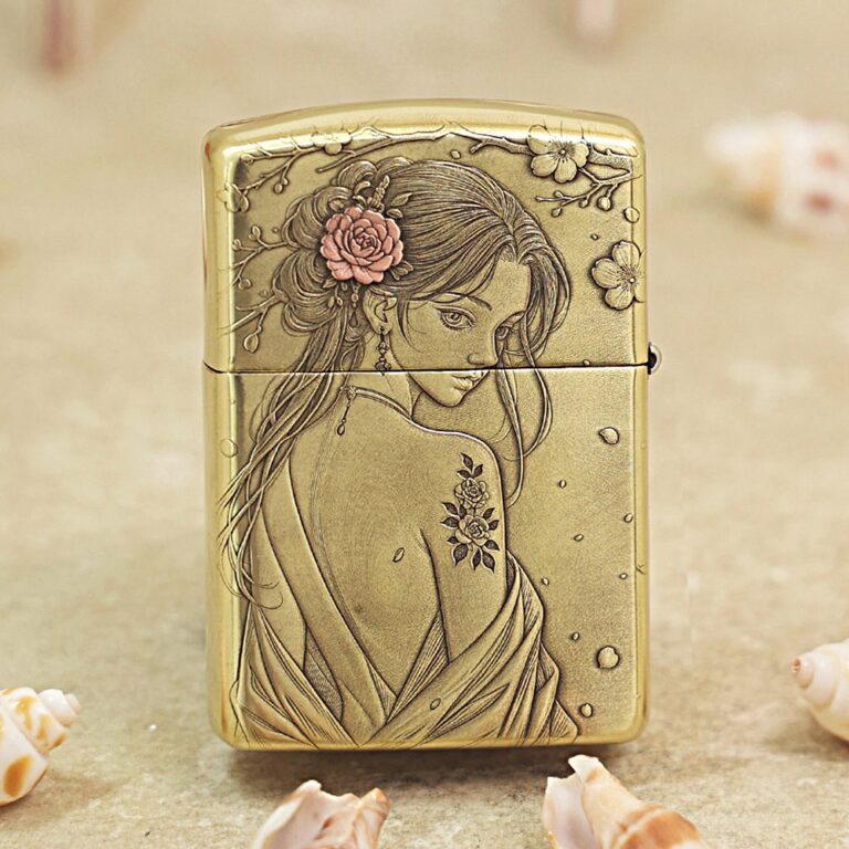 Gold Zippo lighter engraved with a woman in a flowing dress and flowers in her hair.