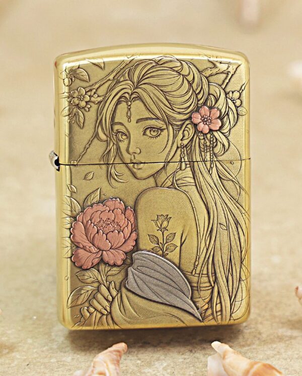 KZ509 Gold engraved lighter featuring a stylized woman with flowers in her hair and detailed line art of blossoms at the shoulder area.