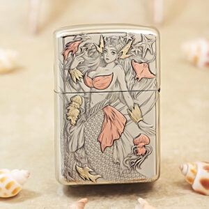 Metal lighter with an engraved mermaid design, pink-orange accents and sea-life details on a silver surface.