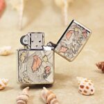KZ554 sea-life and koi engraving shown with the silver-tone lighter open