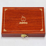 Wooden Zippo branded presentation box with gold trim and latch, closed.