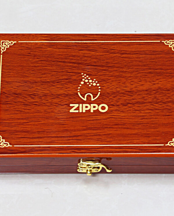 Wooden Zippo branded presentation box with gold trim and latch, closed.