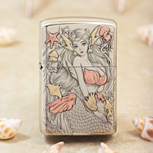 Metal lighter with a detailed mermaid illustration in pale pink and gold tones, other sea motifs around her.