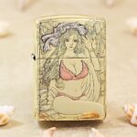 KZ555 high-polish brass Zippo Armor lighter with pink-accented Beach Beauty artwork