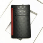 Reverse of S.T. Dupont MaxiJet 20160N showing matte black perforated pattern and red trigger