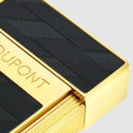 Close-up of black Monogram 1872 pattern and gold S.T. Dupont logo on Biggy 025079