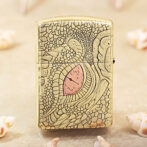 Gold Zippo lighter with an embossed, reptile-scale pattern and a pink heart accent in the center.