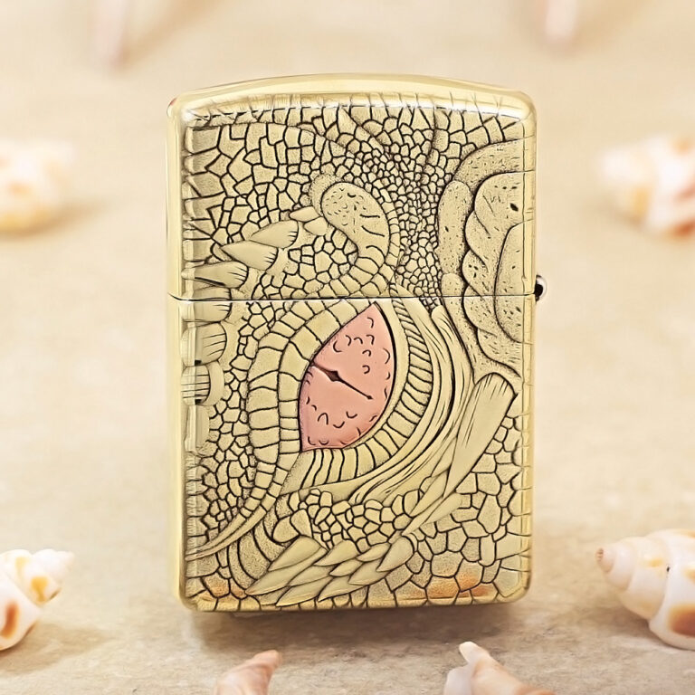 Gold Zippo lighter with an embossed, reptile-scale pattern and a pink heart accent in the center.