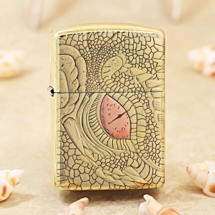 KZ371 high-polish brass Zippo Armor lighter with dragon-scale engraving and pink-red eye accent