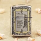 Ornate chrome Zippo-style lighter on a sandy beach with seashells nearby.