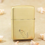 Gold metal lighter with a minimalist line drawing of a cat reaching for a butterfly, a small red heart above the butterfly.