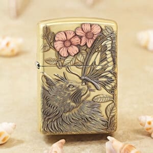 Beige metal lighter with a detailed engraving of a wolf, butterfly, and pink flowers among leaves.