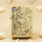 Gold-tone Zippo-style lighter with an engraved Tom and Jerry scene in a garden, showing Tom, Jerry, and flowers