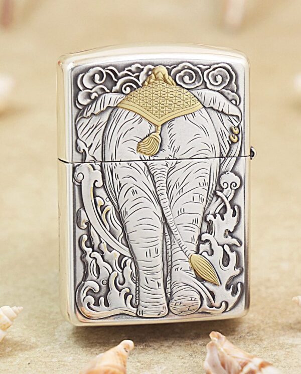 KZ127-01 Silver Zippo-style lighter with an embossed elephant design, gold headdress detail, surrounded by ornate clouds and patterns.