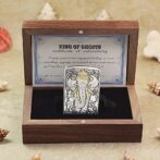 Decorative metal lighter with an ornate elephant design in a wooden presentation box.