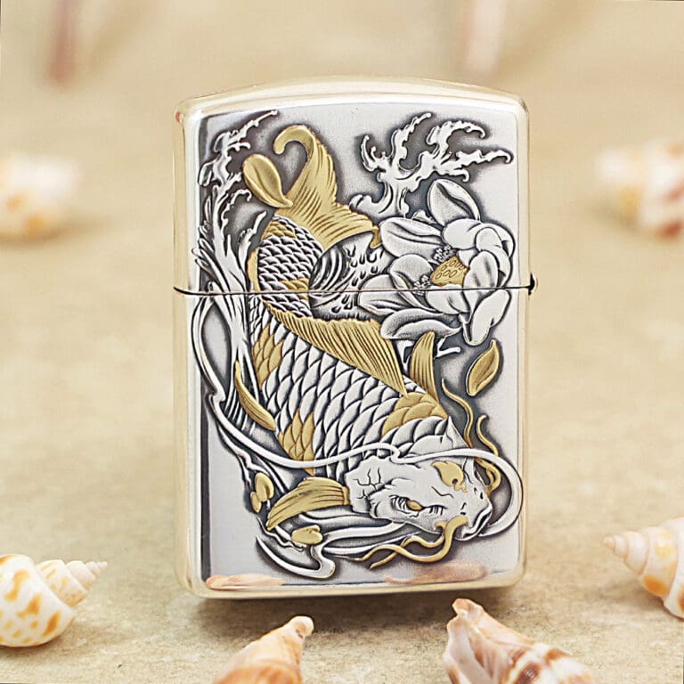Metal Zippo-style lighter with an embossed koi fish and floral design in gold and silver tones.