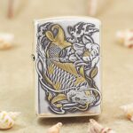 KZ136 silver-tone Zippo Armor lighter with raised gold-tone koi fish, waves and flowers